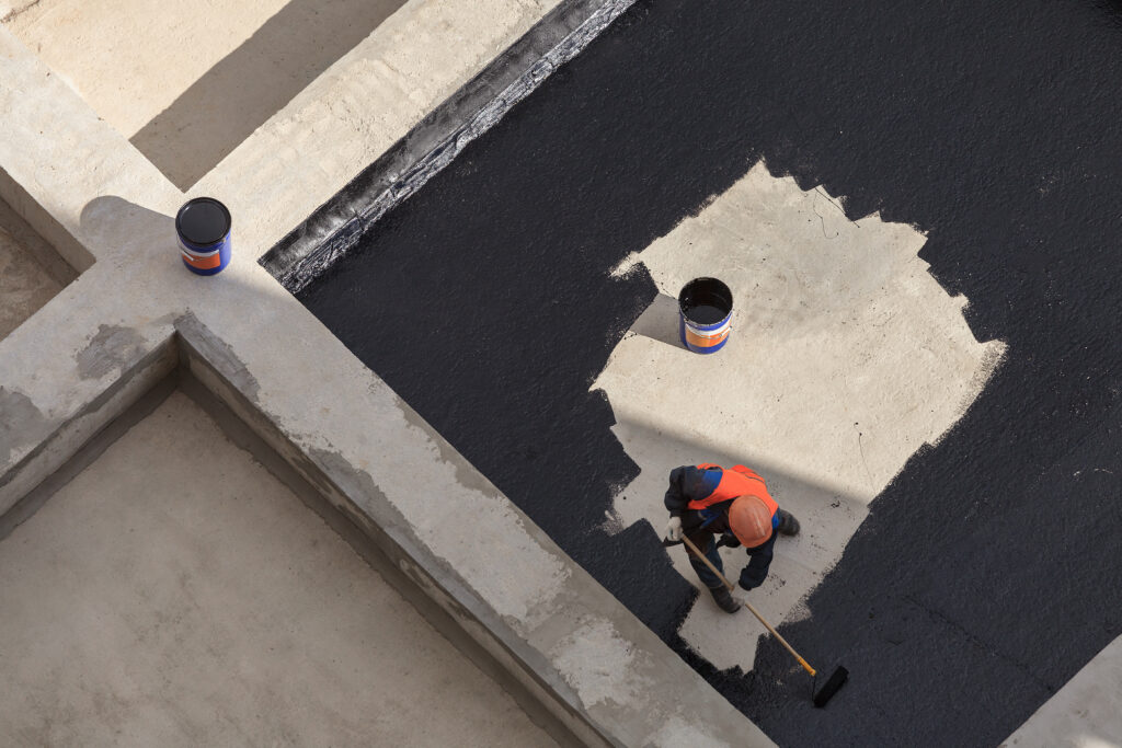Worker waterproofing plaza deck
